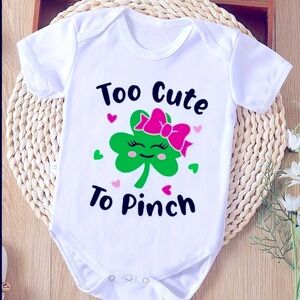 Onesie with decal reading “Too Cute to Pinch”.
